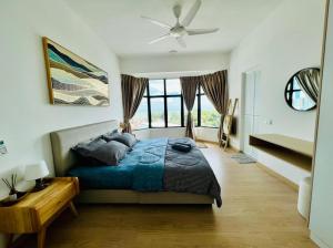 a bedroom with a blue bed and a large window at Mutiara Melaka Beach Resort SeaView in Kampong Bukit Darat +19 photos