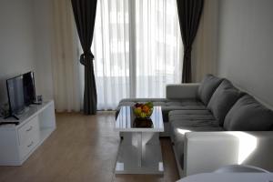 a living room with a couch and a table with fruit on it at Lux Kalimera Apartments in Ulcinj