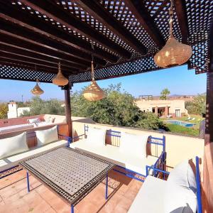 a patio with white couches and a table at Villa Belle vue - with a private & Heated pool in Marrakesh