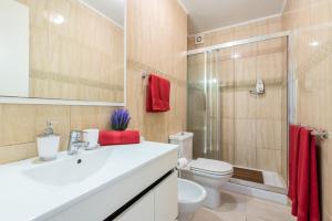 a bathroom with a sink and a toilet and a shower at Apto JACARANDA LAS AMERICAS in Playa de las Americas