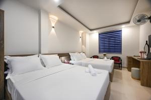 Ένα ή περισσότερα κρεβάτια σε δωμάτιο στο Hotel Trung Mai-Tân Bình