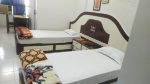 Postel nebo postele na pokoji v ubytování Hotel Dilip
