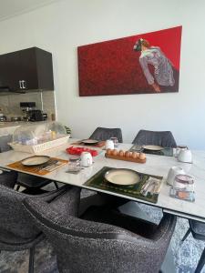 a table with chairs and a table with food on it at New 2BR Villa Private Pool Near Seminyak in Kerobokan