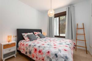 a bedroom with a bed and a ladder and a window at Albatros in Casares +19 photos