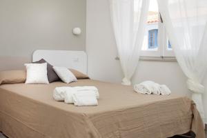 a bedroom with a bed with towels on it at I Viaggi di Ki in Santa Teresa Gallura