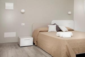 a bedroom with a bed with two pillows on it at I Viaggi di Ki in Santa Teresa Gallura