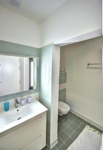 a bathroom with a sink and a toilet at Valletta Central Apartment in Valletta