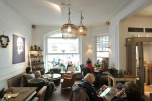 a group of people sitting in a living room at Gästehaus Cafe Orth Zimmer 21 in Westerland (Sylt)