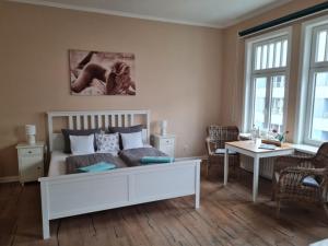 a bedroom with a bed and a living room at Gästehaus Cafe Orth Zimmer 21 in Westerland (Sylt)