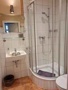 a bathroom with a shower and a sink at Gästehaus Cafe Orth Zimmer 21 in Westerland (Sylt)