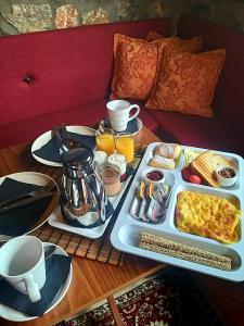 a table with a tray of breakfast food on it at Arolithos-Kaimaktsalan in Palaios Agios Athanasios +14 photos