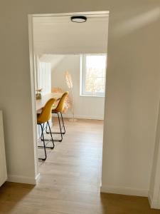 a dining room with a table and chairs and a window at Chambre et salle de bain privative in Liège