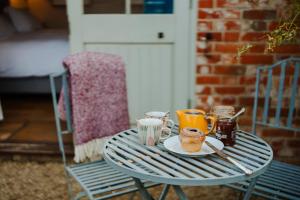 a blue table with cups and saucers on it at Crepe Farm Barns in Bridport