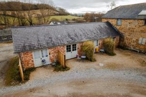 an aerial view of a brick house with two white doors at Crepe Farm Barns in Bridport