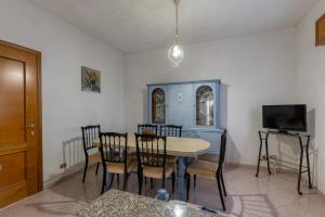 a dining room with a table and chairs and a tv at Casa Bellavista in Siderno Marina