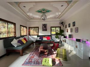 a living room with a couch and a table at Purple House - Female only Boutique hostel in Koh Phangan