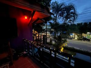 a room with a balcony with a view of a street at Purple House - Female only Boutique hostel in Koh Phangan