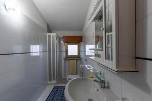 a white bathroom with a sink and a toilet at Casa Bellavista in Siderno Marina +51 photos