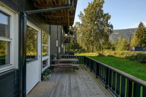a porch of a house with a bench on it at Hafjell Alpinlandsby Apartment 43 in Hafjell