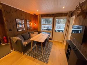 a living room with a couch and a table at Hafjell Alpinlandsby Apartment 43 in Hafjell