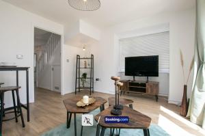 a living room with a tv and a table at Cozy House By AR Properties Short Lets & Serviced Accommodation Colchester in Colchester