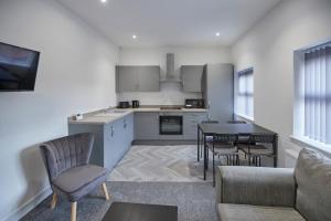 a kitchen and living room with a table and chairs at Zetland House Apt 4 in Loftus