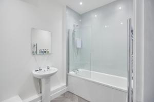 a white bathroom with a sink and a shower at Zetland House Apt 4 in Loftus