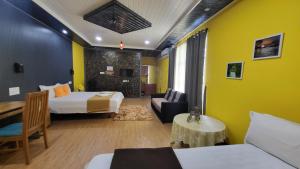 a hotel room with two beds and a couch at Bell Farms and Resorts in Munroe Island