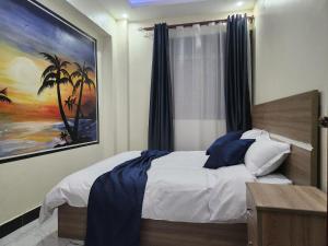 Postel nebo postele na pokoji v ubytování EQUATOR SUITES -KAMPALA -Ivory Mall -Bunga Gaba Road