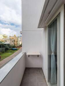 a balcony with a window with a bench on it at Blue Pavilion by Red Olive Electronic city in Bengaluru