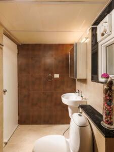 a small bathroom with a toilet and a sink at Blue Pavilion by Red Olive Electronic city in Bengaluru +21 photos