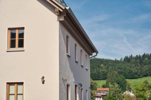 a white building with windows on the side of it at Haus Herzbluat in Peiting