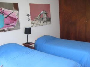 En eller flere senge i et værelse på Casa Pala Luar