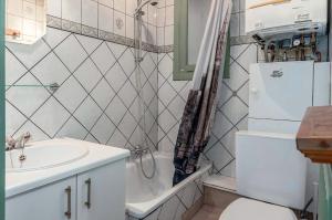 a bathroom with a sink and a white refrigerator at Europe 0402 in Sint-Idesbald