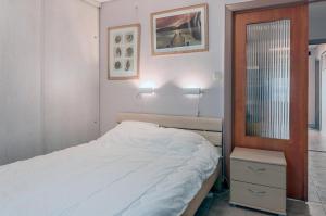 a bedroom with a bed and a dresser and a mirror at Europe 0402 in Sint-Idesbald