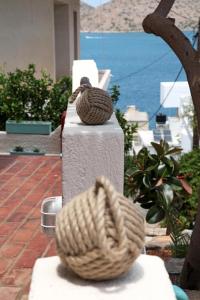 a coil of rope sitting on top of a stone pillar at Elounda Relax Apartment in Elounda