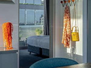 a hotel room with a bed and a yellow purse at The Olsen Melbourne Art Series in Melbourne