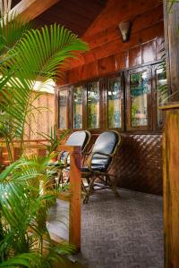 a train car with two chairs and a table at Sameer beachfront Cottages in Canacona