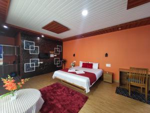 a bedroom with a bed and a red wall at Bell Farms and Resorts in Munroe Island