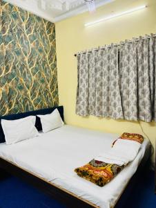 Postel nebo postele na pokoji v ubytování RR Guest House