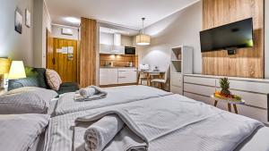 Posteľ alebo postele v izbe v ubytovaní Apartamenty Sun & Snow Resort Karkonosze