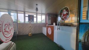 a room with a bathroom with a green floor at Bell Farms and Resorts in Munroe Island