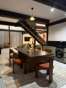 a kitchen with a large wooden table and chairs at Fachwerk Borovoe in Shchūchīnsk
