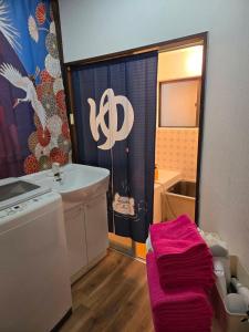 a bathroom with a sink and a bath tub at BandK Kouenji in Tokyo +27 photos