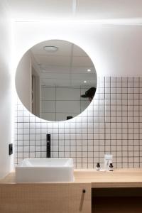 a bathroom with a sink and a mirror at CENTRAL Hôtel Bordeaux Centre in Bordeaux +15 photos
