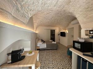 a hotel room with a bed and a living room at Le Marangi Getaway Suite in Martina Franca
