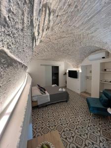 a bedroom with a bed and a room with a couch at Le Marangi Getaway Suite in Martina Franca