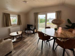 a living room with a table and chairs at Vakantiepark Schouwen in Renesse