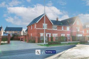 a large red brick house on a street at 2 Bedroom House By AR Properties Short Lets & Serviced Accommodation Colchester with Garden in Colchester