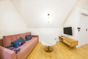 a living room with a couch and a table at Apartament Parkowa 9 PENTHOUSE in Lesko